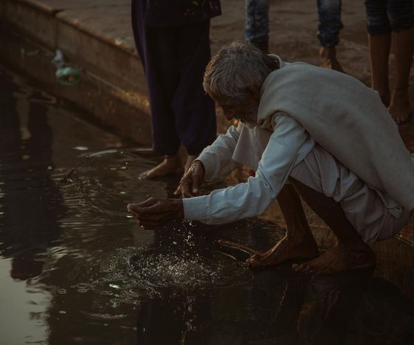 A person sitting calmly by a window, integrating a moment of peace into their day.